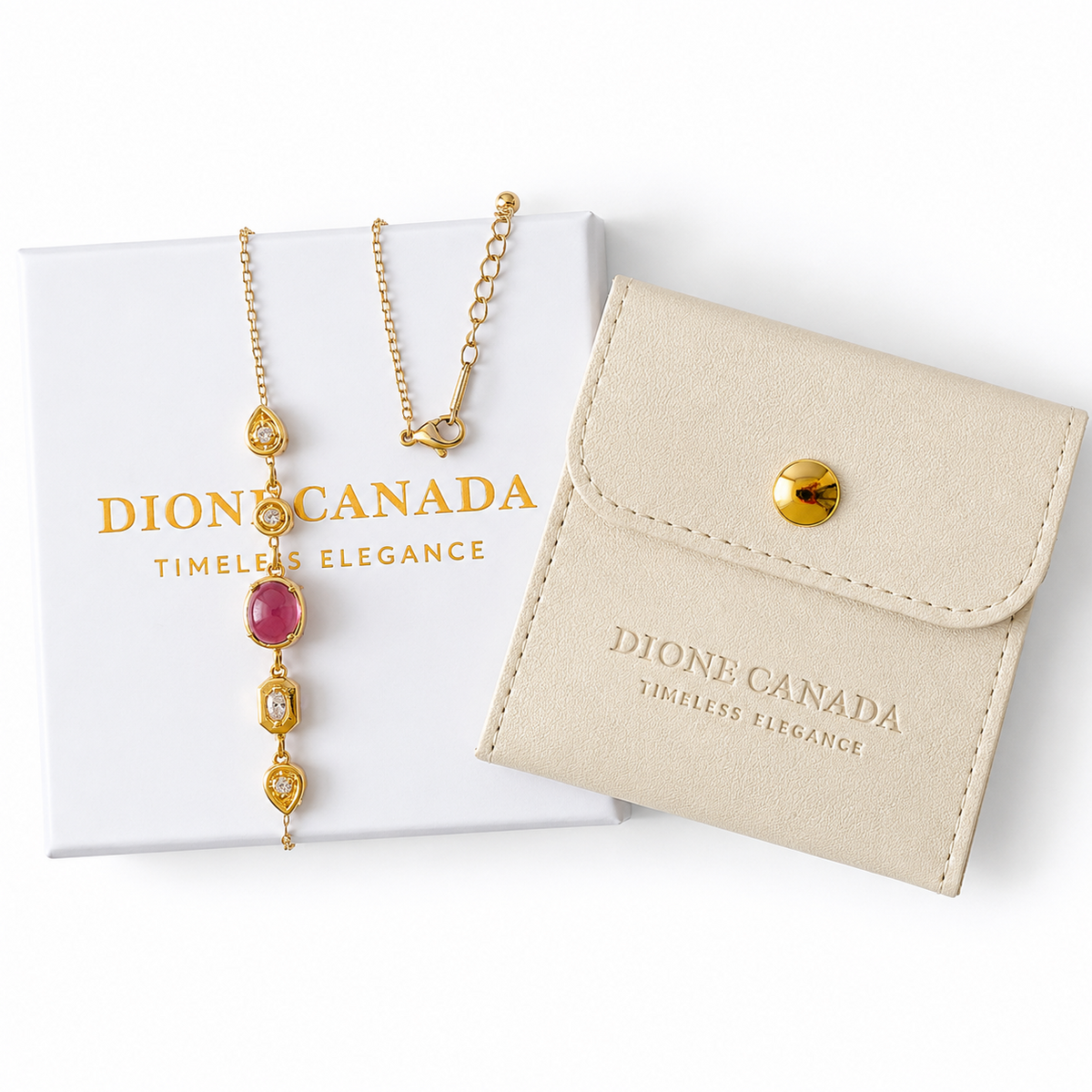 Gold-toned necklace with a pink oval stone and clear crystal accents, displayed beside a white DION CANADA box and a cream leather jewelry pouch on a white background.