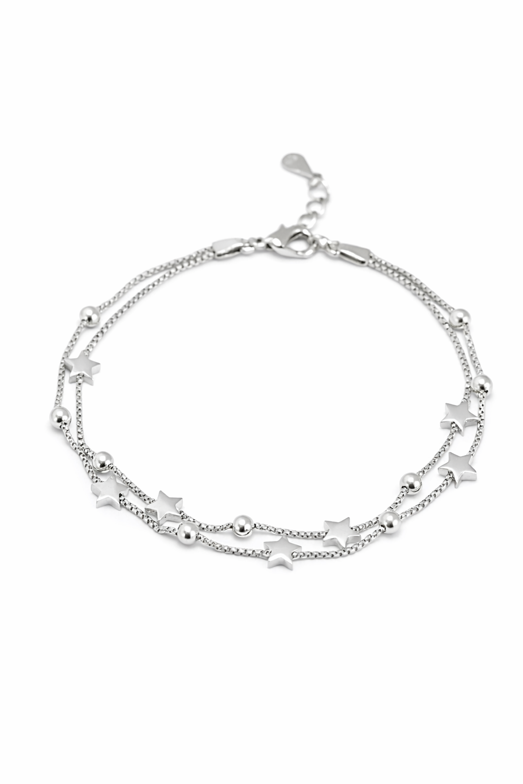 Silver bracelet with star and ball charms on a white background