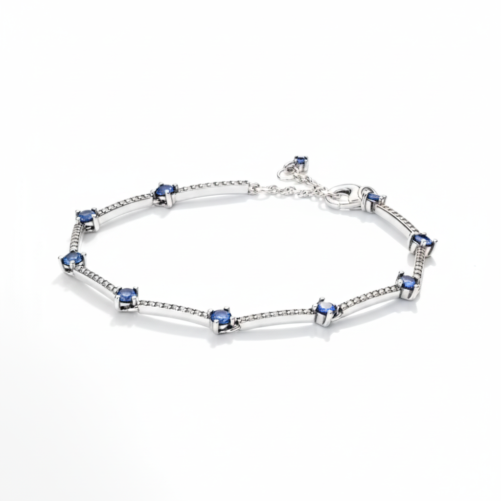 Blue Orbit Chain Bracelet in 925 sterling silver featuring heart-link design with blue gemstone accents by Dione Canada