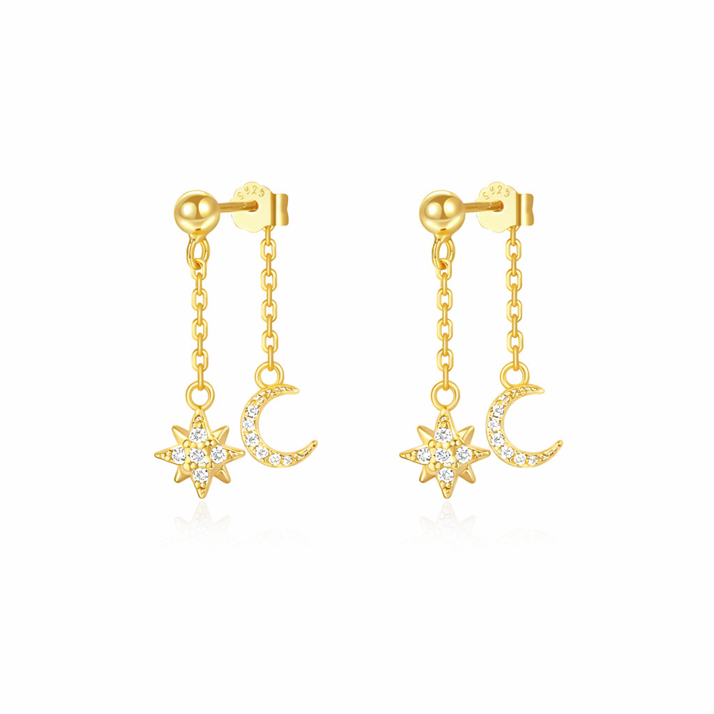 Gold earrings with star and moon designs on a white background