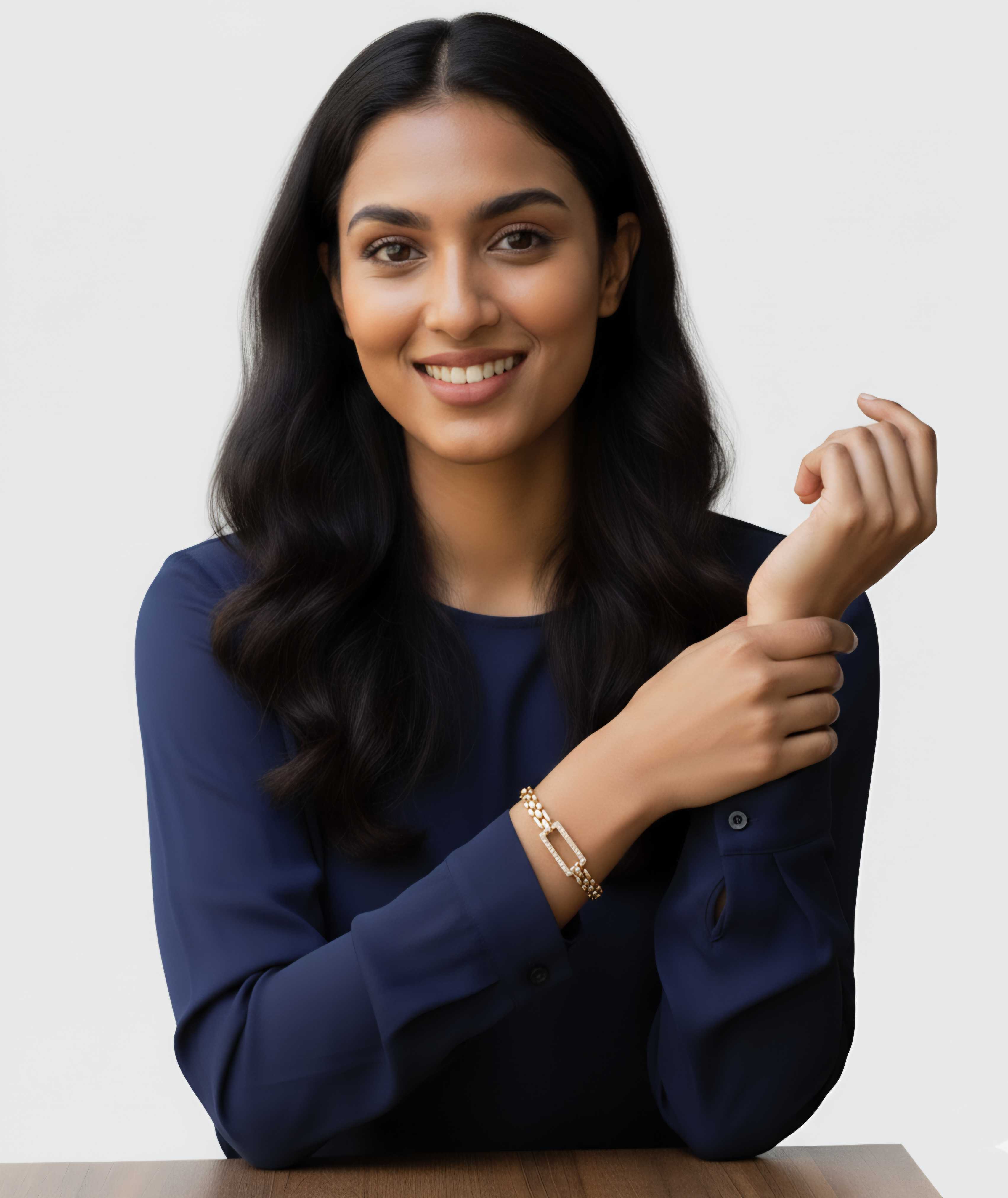 Model wearing a gold chain-link bracelet from Dione Canada in a clean studio portrait.
