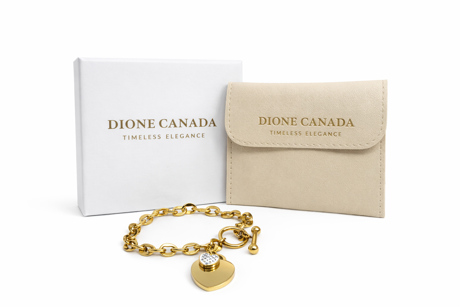 
Dione Canada gold heart charm chain bracelet with crystal detail displayed with jewelry box and pouch
