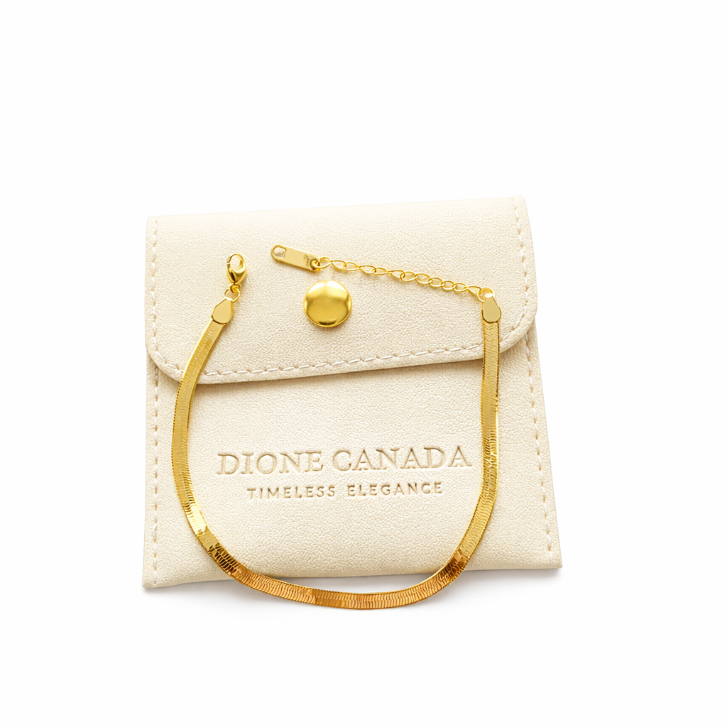 Dione Canada gold herringbone bracelet displayed on branded jewelry pouch
