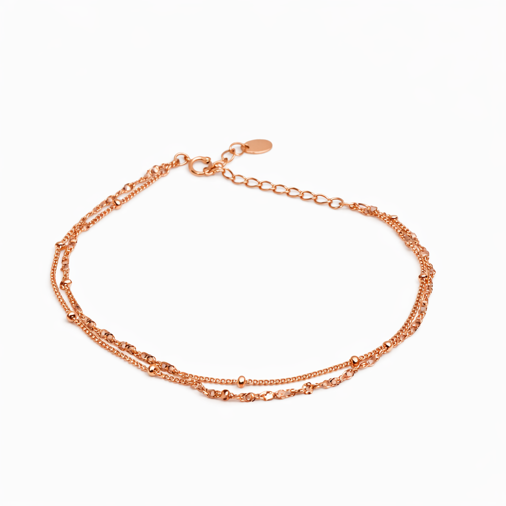 Dione Canada rose gold layered chain bracelet with adjustable clasp on white background
