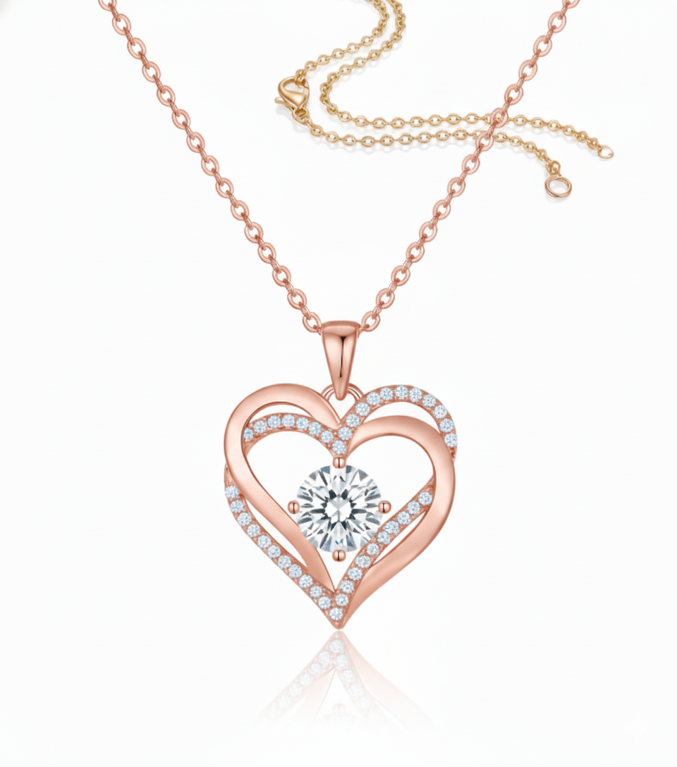 Eternal Heart Pendant in S925 sterling silver electroplated in gold with a red birthstone and double-heart motif with crystal accents by Dione Canada