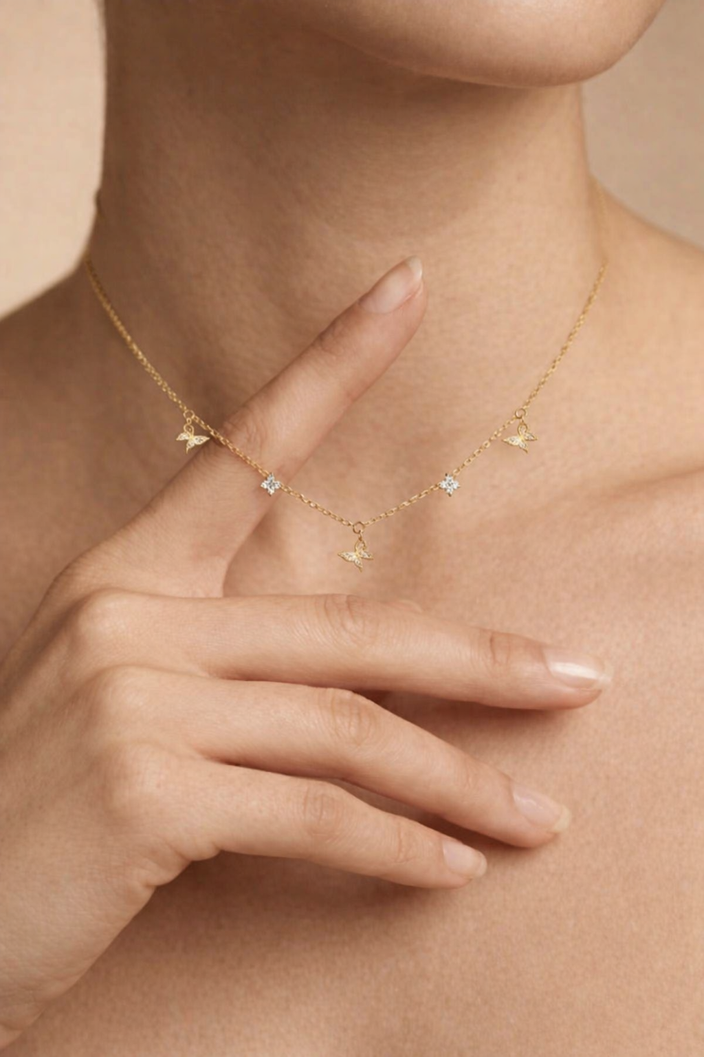 Gold necklace with heart and starfish charms worn by a person