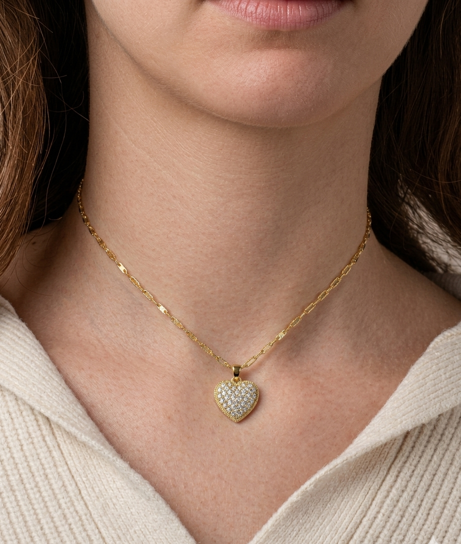 Gold pavé heart pendant necklace with diamond accents worn on model, elegant minimalist jewelry for women