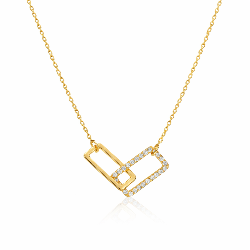 Gold necklace with a geometric pendant on a white background