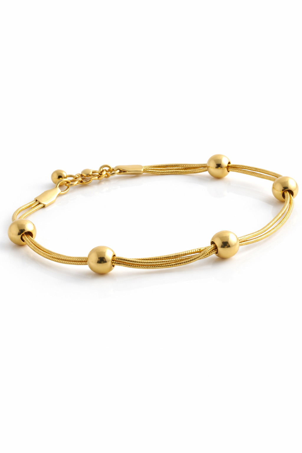 Gold bracelet with spherical beads on a white background