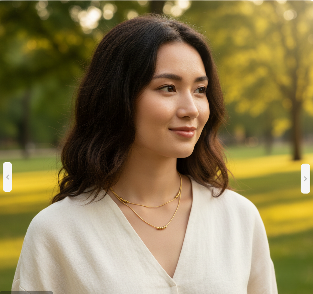 Model wearing Beadline Duo Necklace – waterproof gold-plated stainless steel dual-layer snake chain necklace with bead accents by Dione Canada