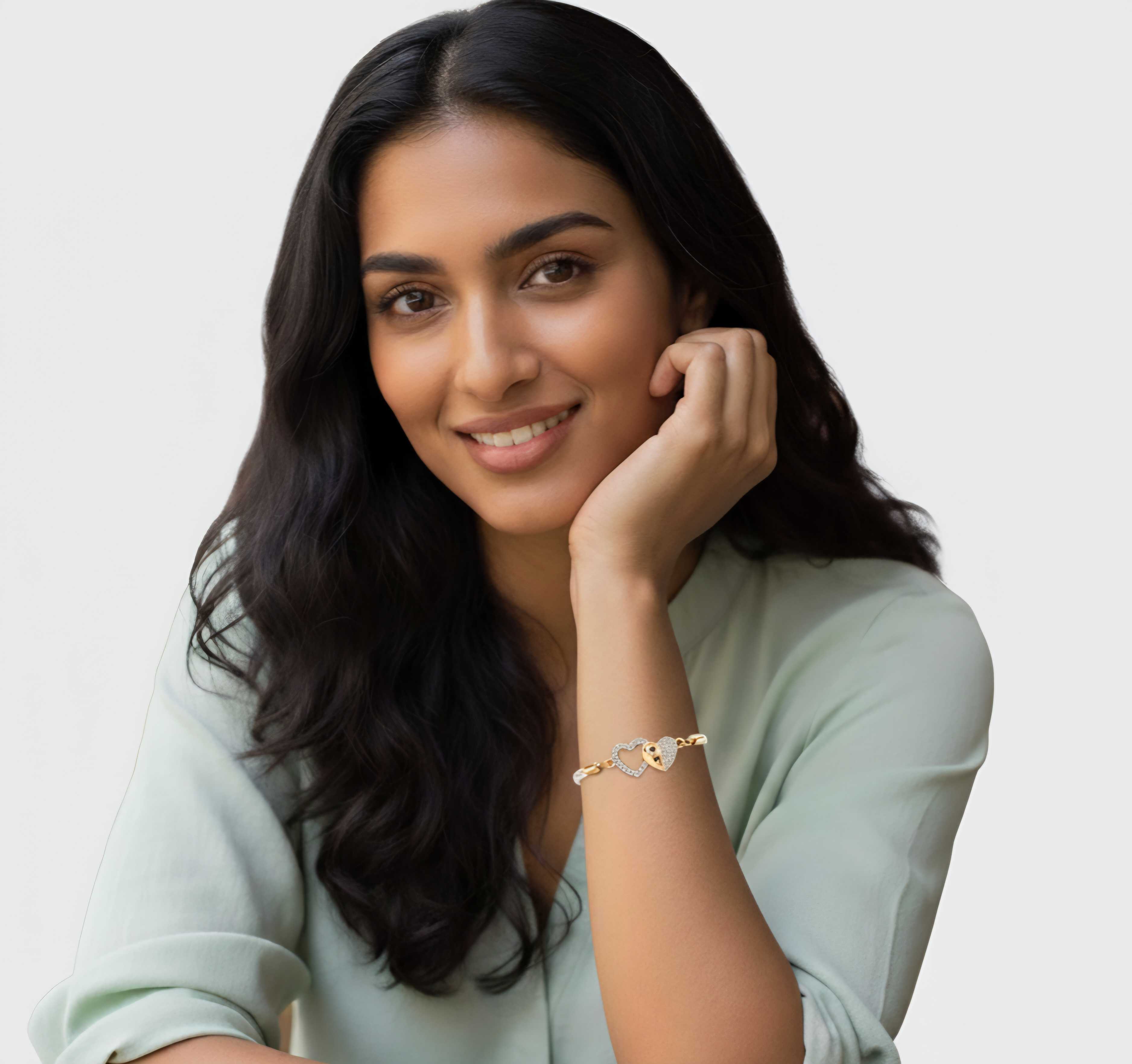 Model wearing Celestial Bond Bracelet – gold-plated copper bracelet with elegant heart motif and adjustable rope chain, designed by Dione Canada