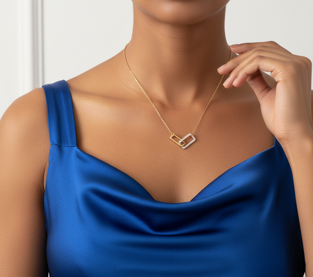 Model wearing Golden Connection Pendant – gold-plated sterling silver pendant with interlocking geometric shapes and subtle rhinestone sparkle by Dione Canada
