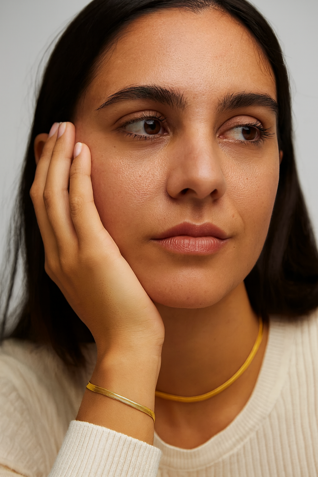 Model wearing Golden Glide Bracelet – gold-plated sterling silver snake-chain bracelet with sleek mirror-like shine by Dione Canada