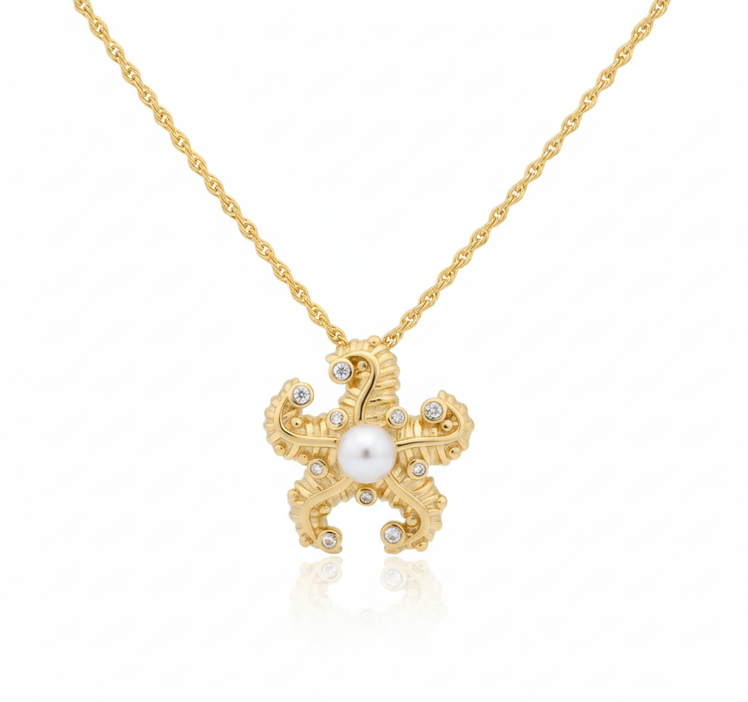 Pearl Crest Pendant in 18K gold-plated copper with starfish motif, crystal inlay and central pearl by Dione Canada