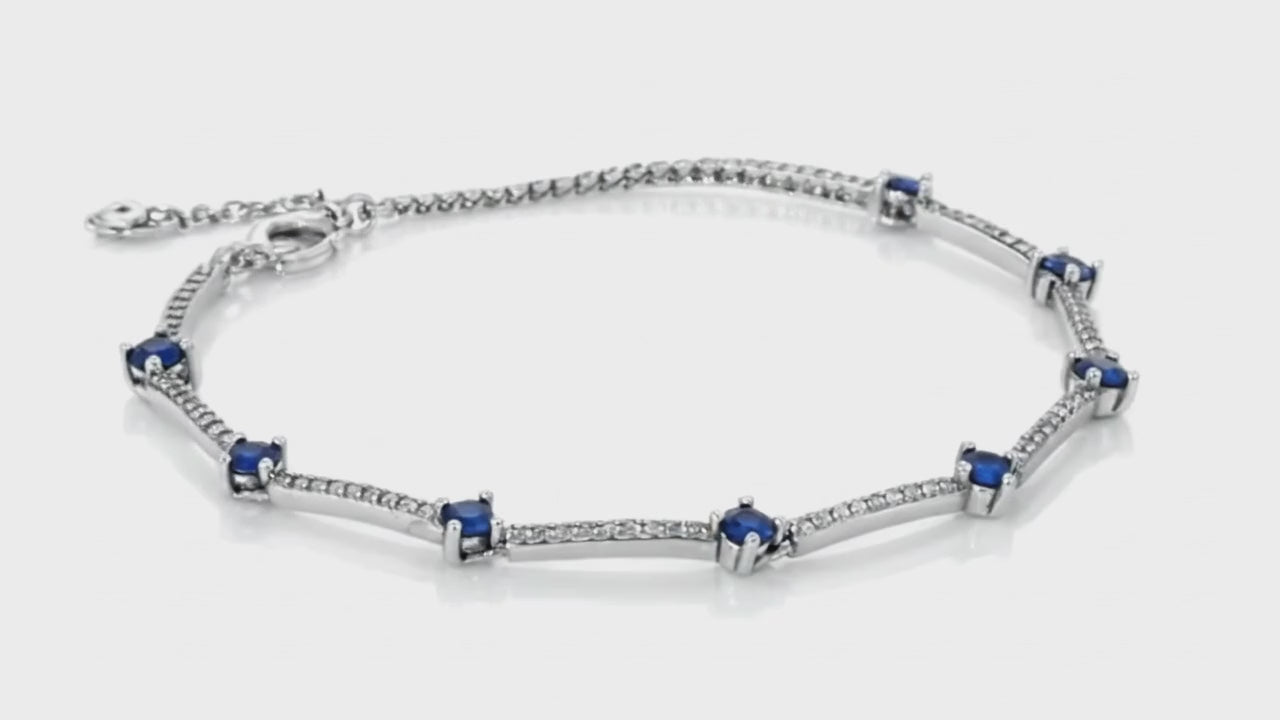 Silver bracelet with blue sapphire accents and shimmering stone detailing by Dione Canada, elegant luxury studio close-up.