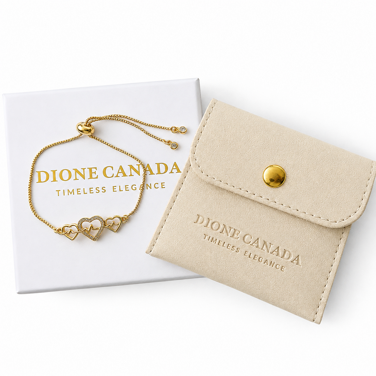 A gold-toned Dione Canada bracelet with three heart charms, displayed with its beige suede-like storage pouch and white presentation box on a clean white background.