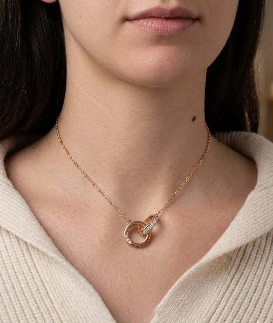 Rose gold interlocking circle pendant necklace with diamond accents worn on model, elegant minimalist jewelry for women
