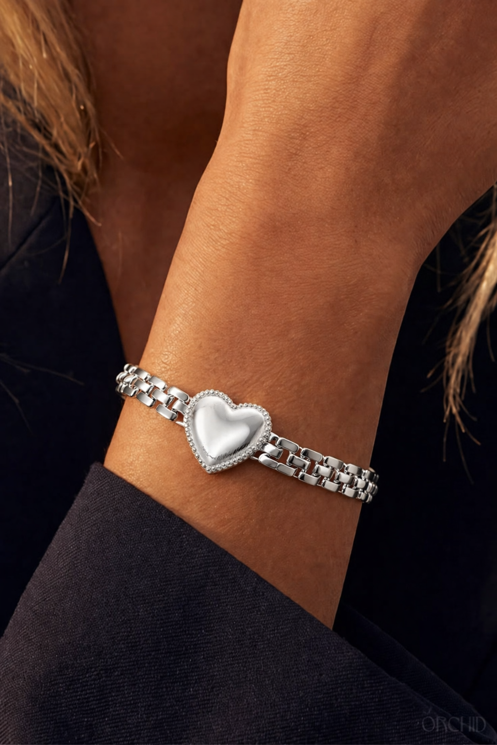 Sterling silver heart chain bracelet worn on wrist, elegant minimalist jewelry for women